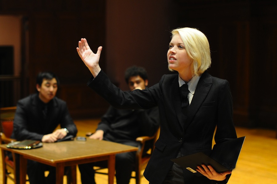 President and Co-Chair Erica Rothberg practices her oratory skills as members of the forensics debate team look on. The team is currently preparing for the National tournament.