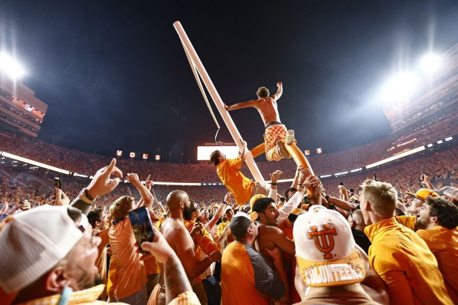 University of Tennessee football fans ride atop a goalpost
after an upset against the University of Alabama.
